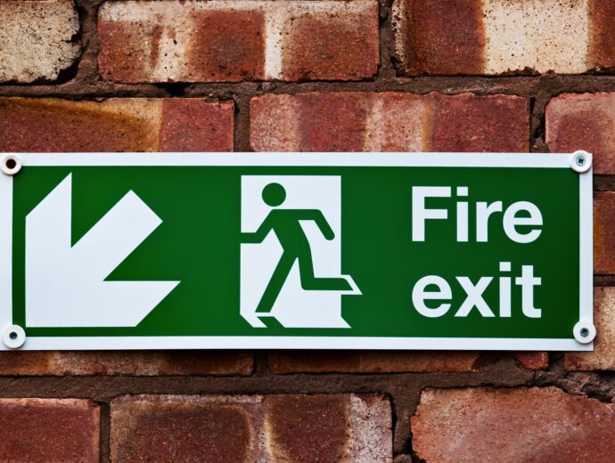 Fire exit sign on brick wall