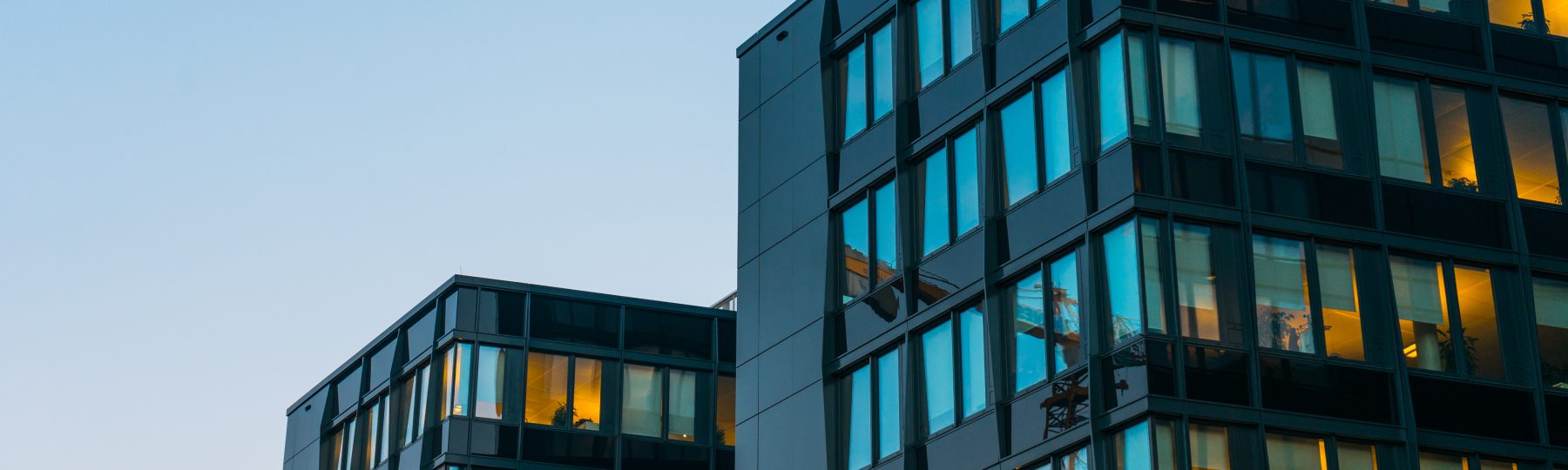 Image of three modern high rise buildings at night